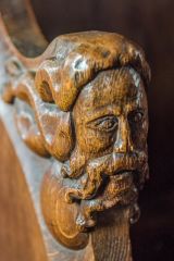 Carved head, chancel bench end