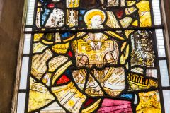 Medieval glass of an angel playing a keyboard instrument