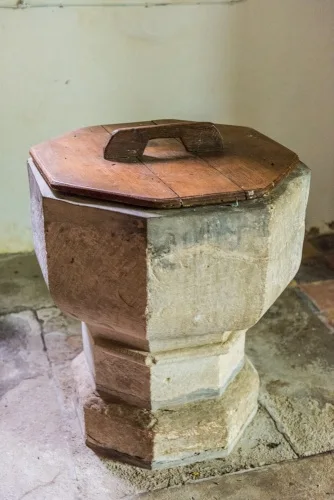 The plainly carved Norman font