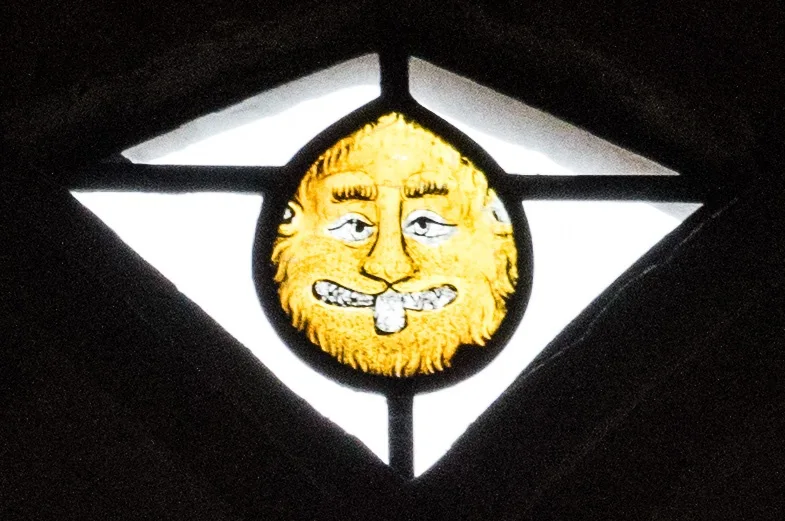 14th century stained glass of a lion's head