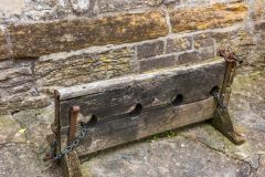 The village stocks outside the churchyard