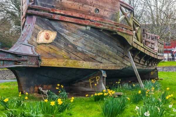 An old boat on the green above the harbour