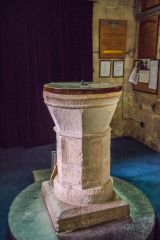 The plainly carved 12th century font