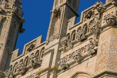 Carved heads on the church tower