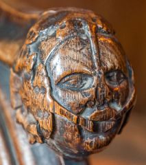 A medieval carved bench end