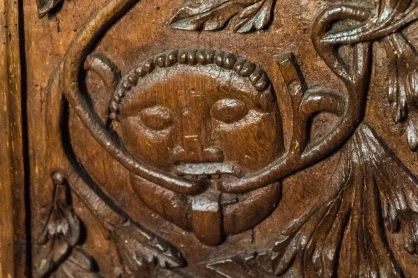 Medieval bench end carved with a Green Man