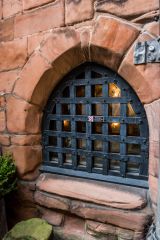 Iron-barred window to the undercroft