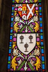 Stained glass depicting coats of arms of Coverdale families