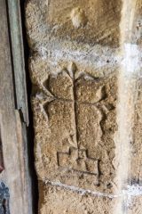 Floriated cross carved into the south door jamb