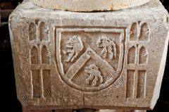 A heraldic panel on the font