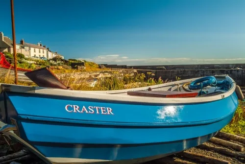 A boat drawn up by the harbour