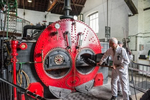 Shovelling coal in the Lancaster boiler