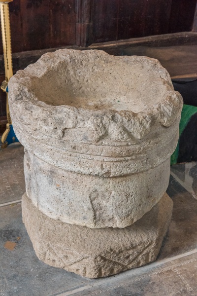 The stone basin/font in St Cuby's Church, Duloe