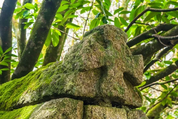 A stone cross atop the wellhead