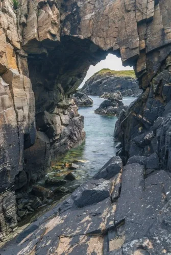Natural sea arch below Dun Eistean
