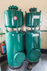 A pair of air compressors near the lighthouse top