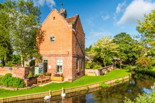 Eardisland Dovecote and swans on the River Arrow