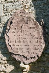 A very worn 1738 memorial plaque