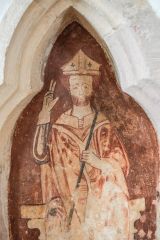 13th-century bishop painted in a sedilia niche