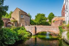 A restored medieval bridge behind the Hospital