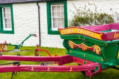 Colourful farm equipment outside the house