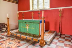 The sanctuary and candle-holders by William Butterfield