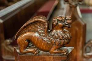 Winged lion bench end