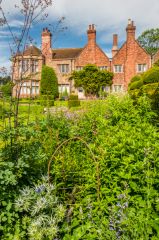 The manor house glimpsed from the garden