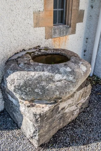 7th-century font bowl outside the church