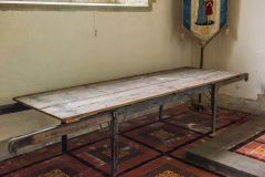 The parish bier, beside the altar