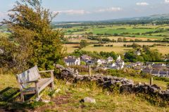 A park bench below the cairn