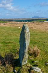 A very slender stone from the side