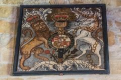 The crudely painted royal coat of arms