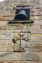 A medieval floriated cross under the west gable