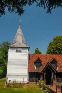 The weatherboarded west tower