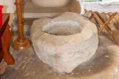 A disused medieval font bowl