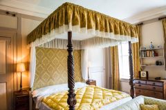 A four-poster bed, first floor