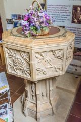 The richly carved 18th-century font