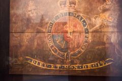 The faded royal coat of arms