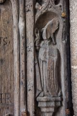 Defaced carving of a saint on the south door