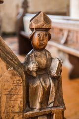 Medieval bench end of a bishop