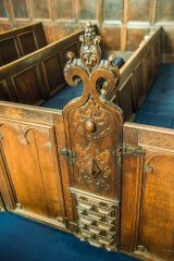 A beautifully carved 17th-century bench end