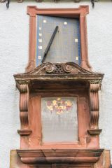 A plaque and sundial over the entrance