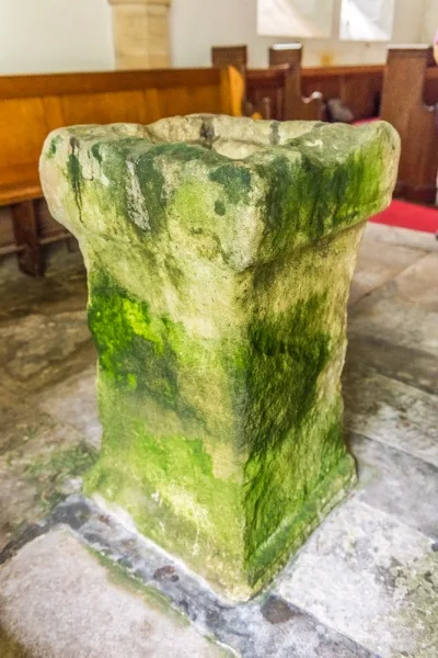 The font, made from a Roman altar