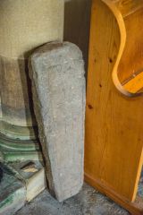 Medieval grave slab against a pillar