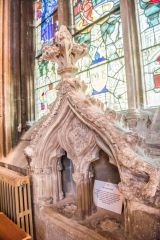 The ornately carved piscina