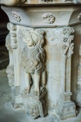 Carved lion supporting the font