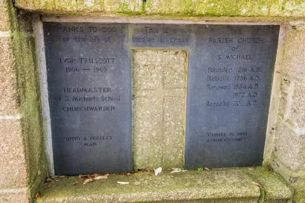 The medieval cross-slab set into a memorial plaque