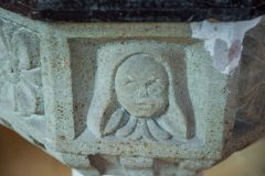 Carved head on the medieval font