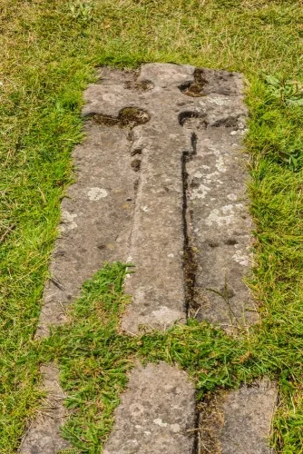 A floriated cross grave slab set into the ground